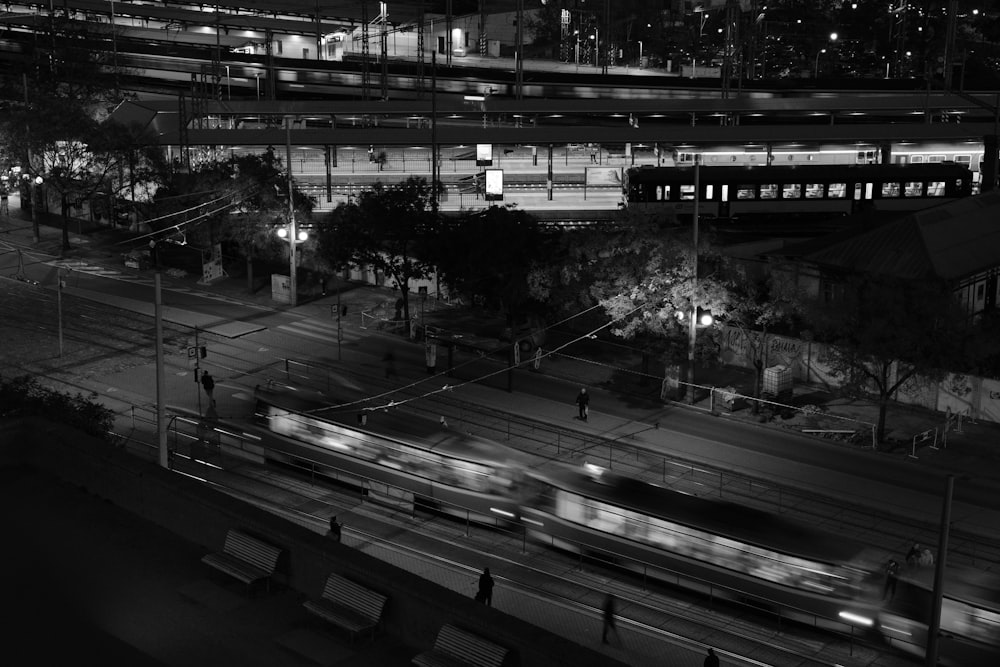 a black and white photo of a train at night