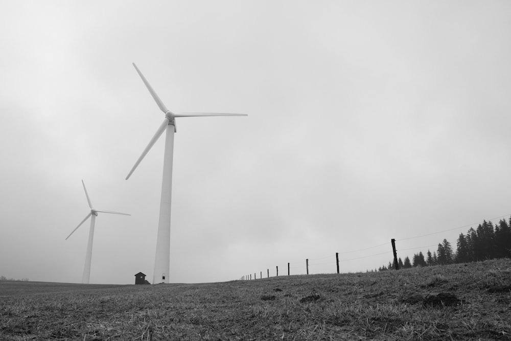 a black and white photo of a wind farm