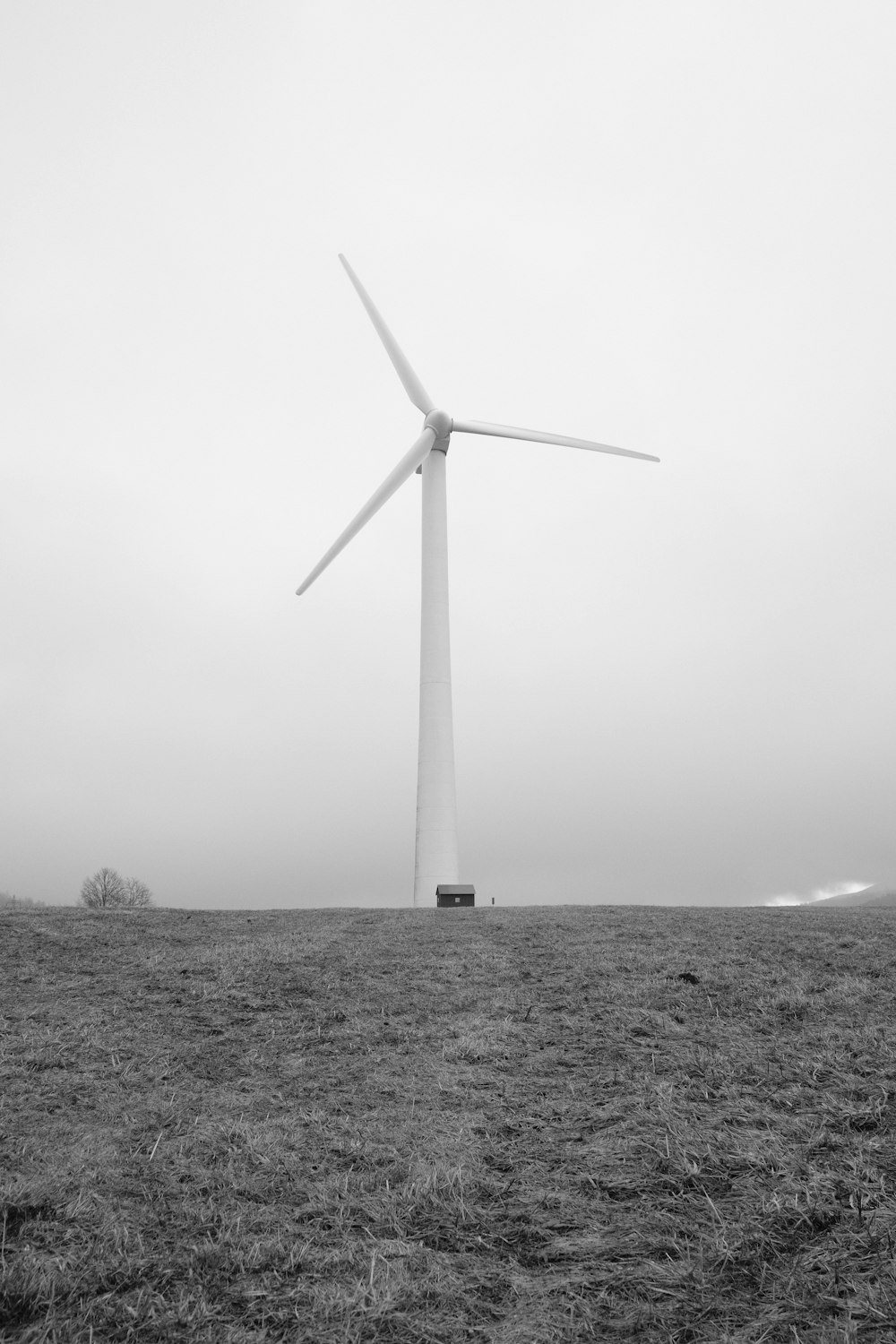 a black and white photo of a wind turbine