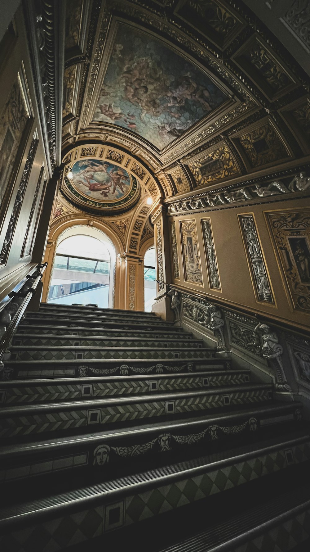 a set of stairs leading up to a painting on the ceiling