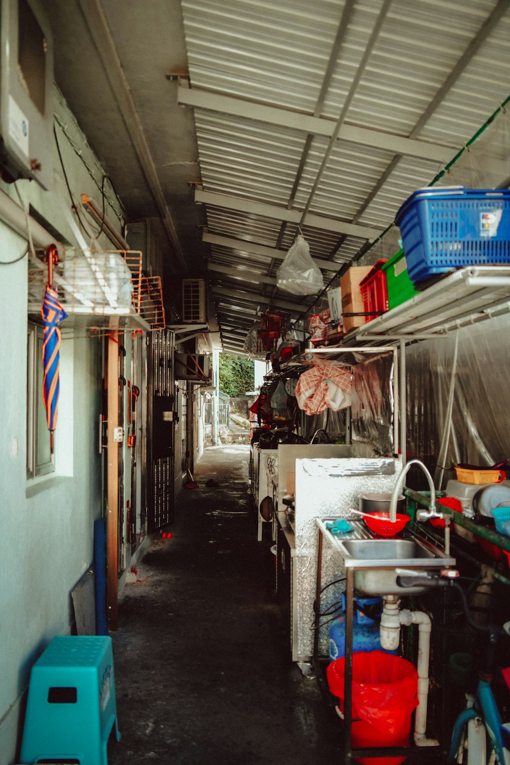 a long narrow room with a bunch of items on the shelves