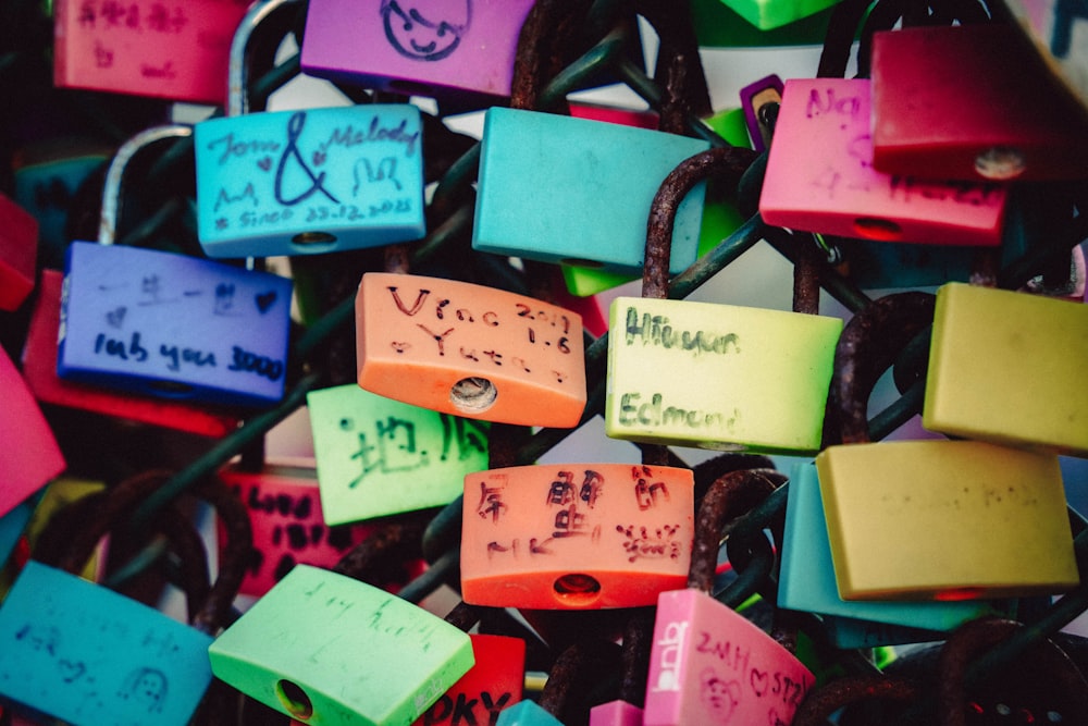 a bunch of colorful padlocks with writing on them