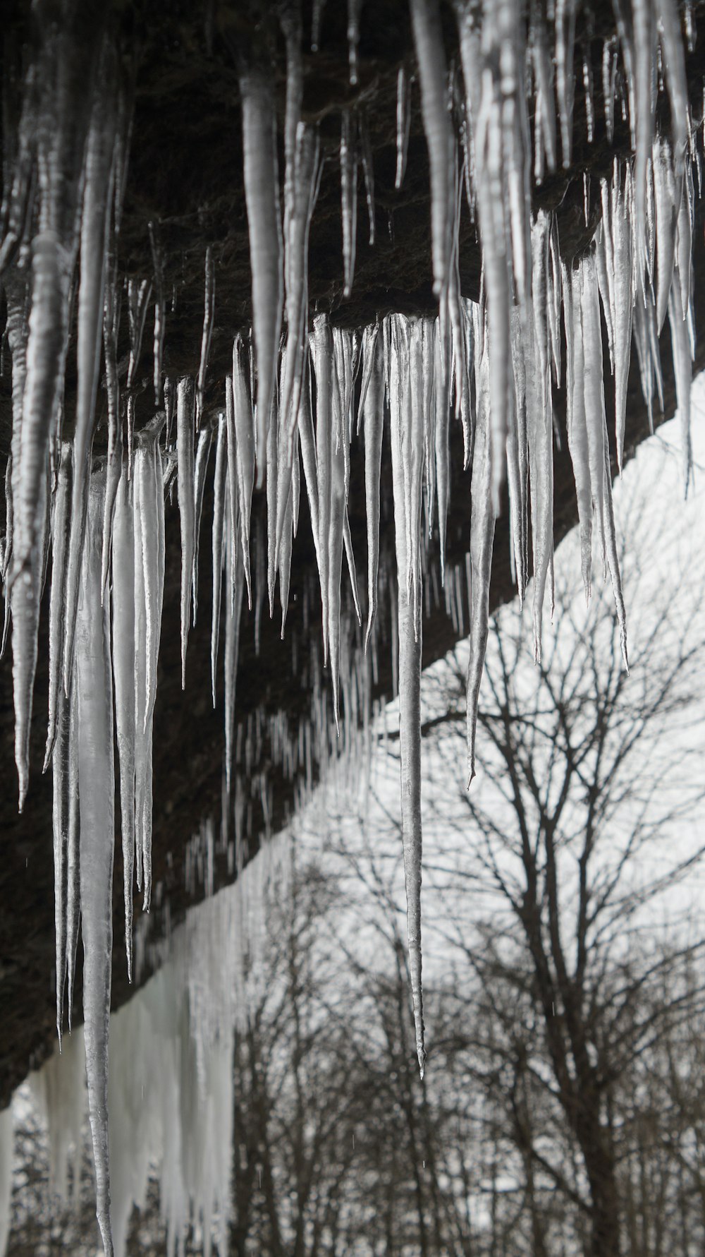 a group of icicles hanging from the side of a mountain