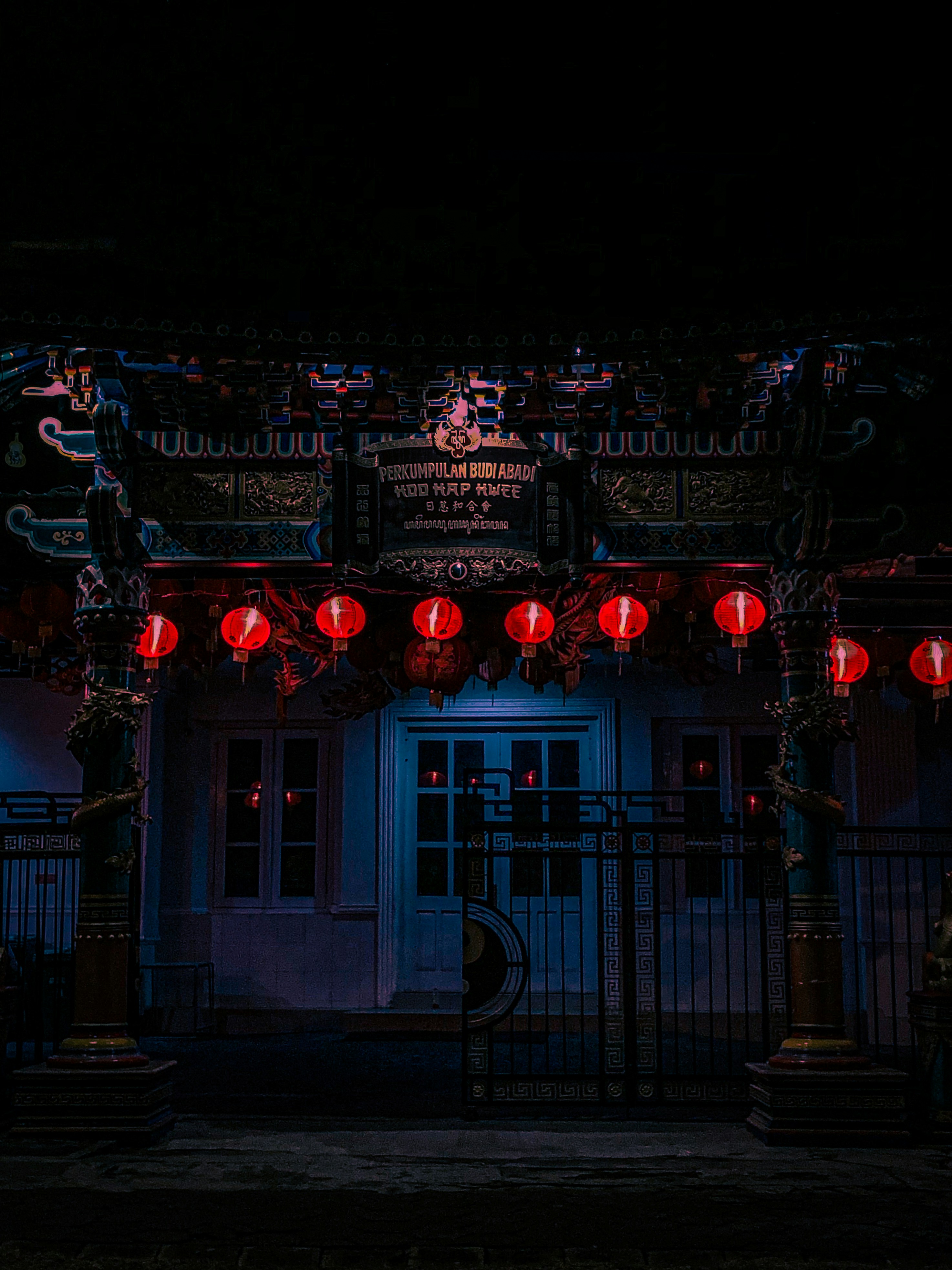 a building with red lanterns hanging from it's roof