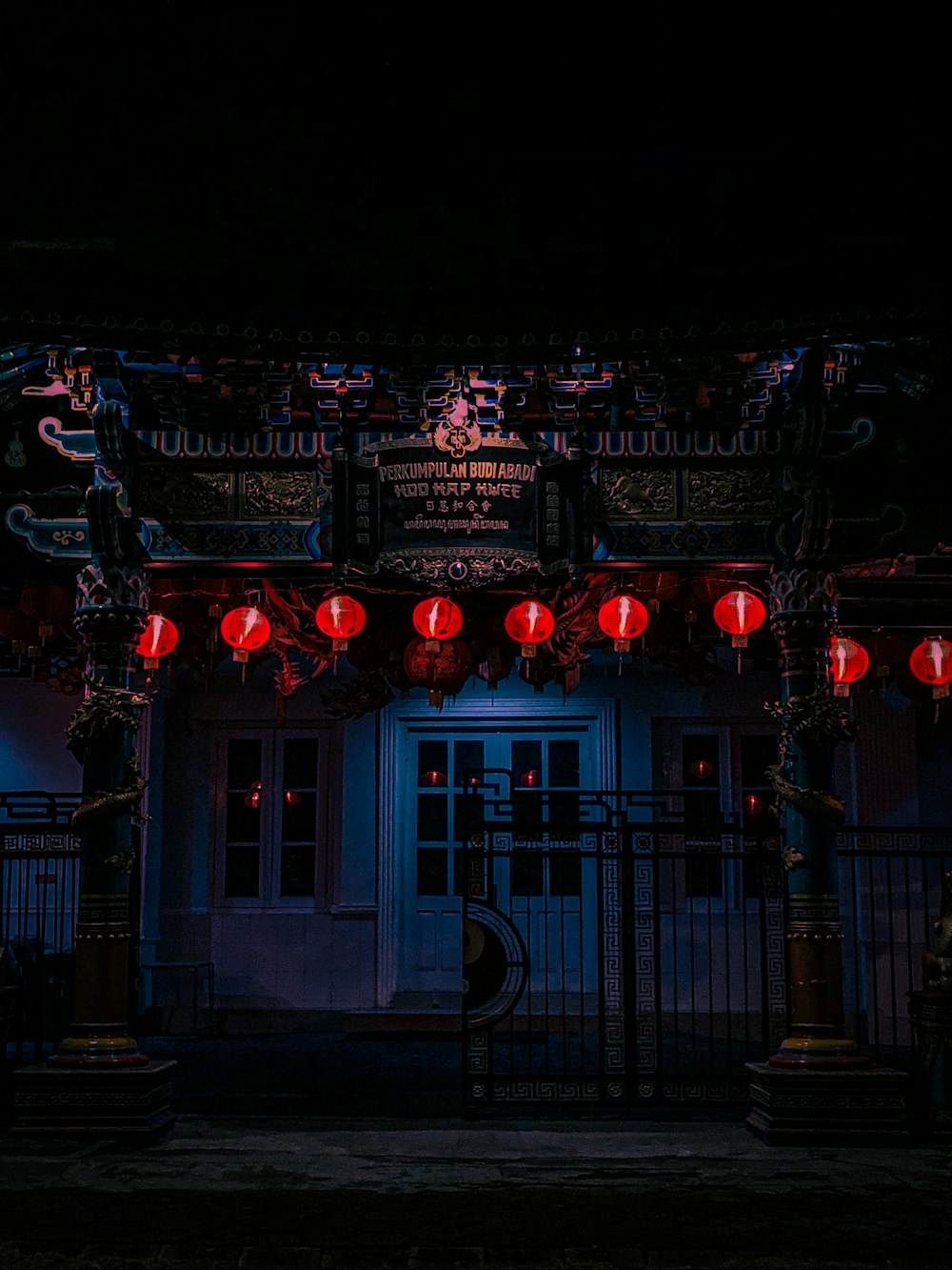 a building with red lanterns hanging from it's roof