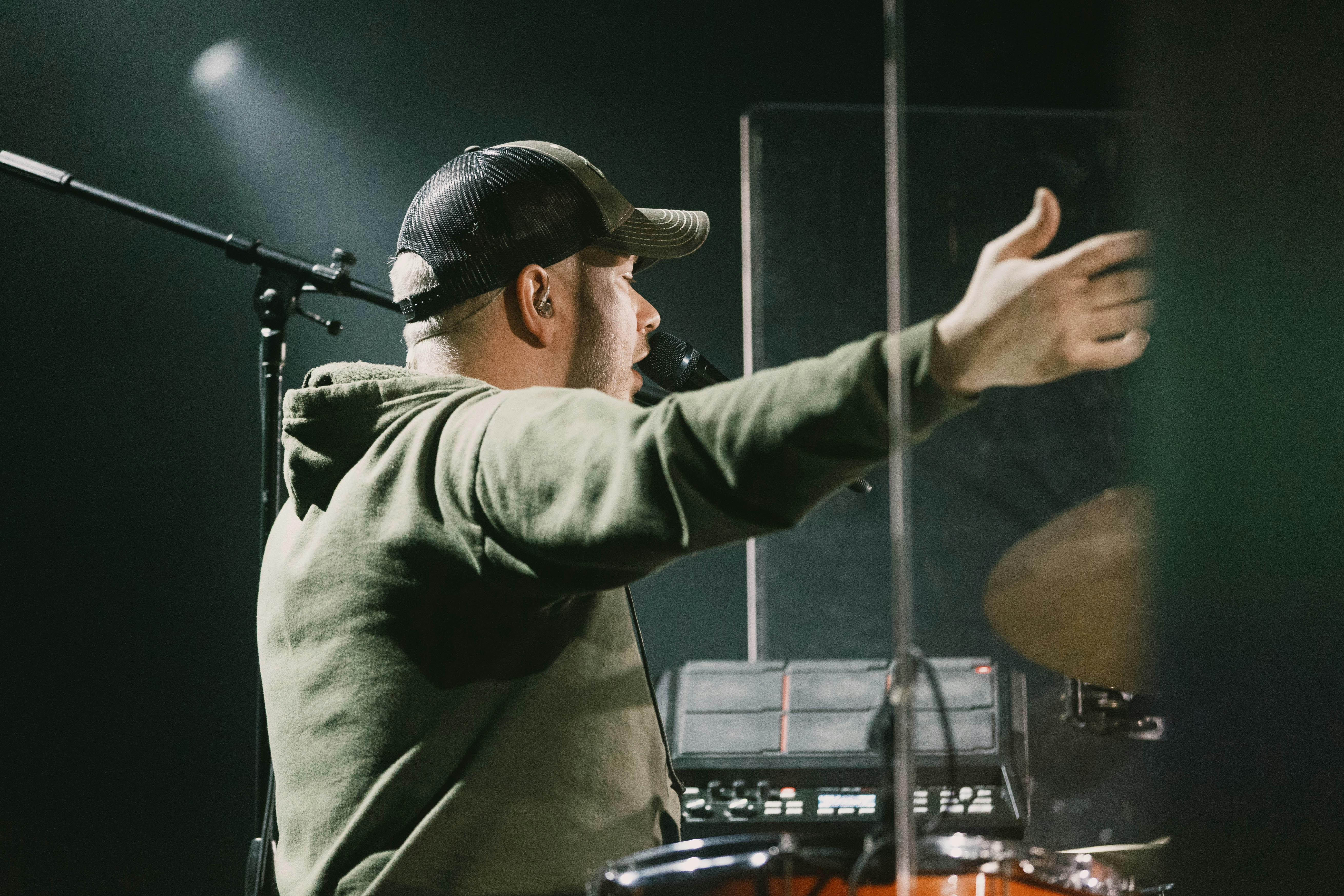 a man in a hat is playing drums