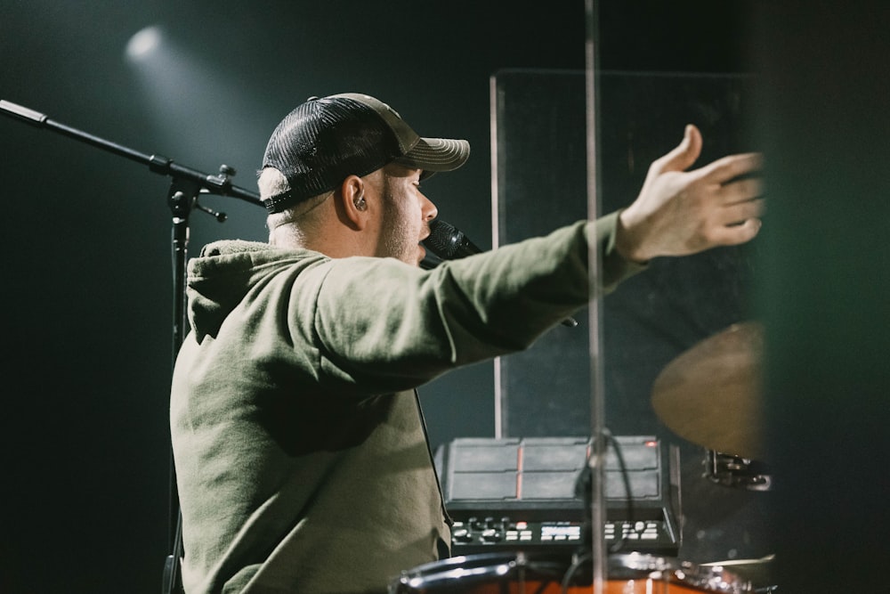 a man in a hat is playing drums