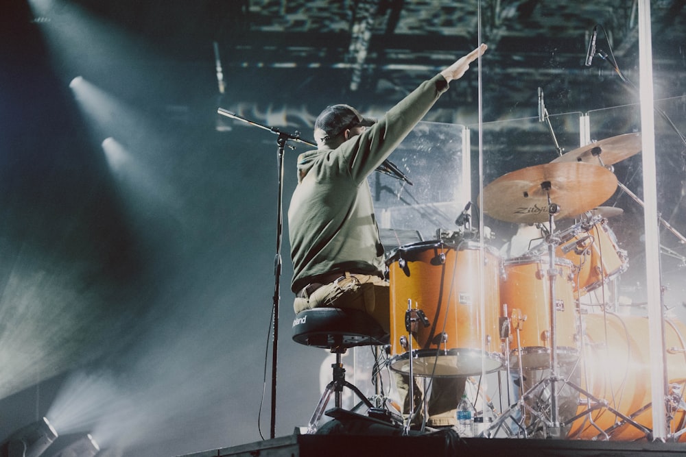 a man standing on top of a stage holding a microphone