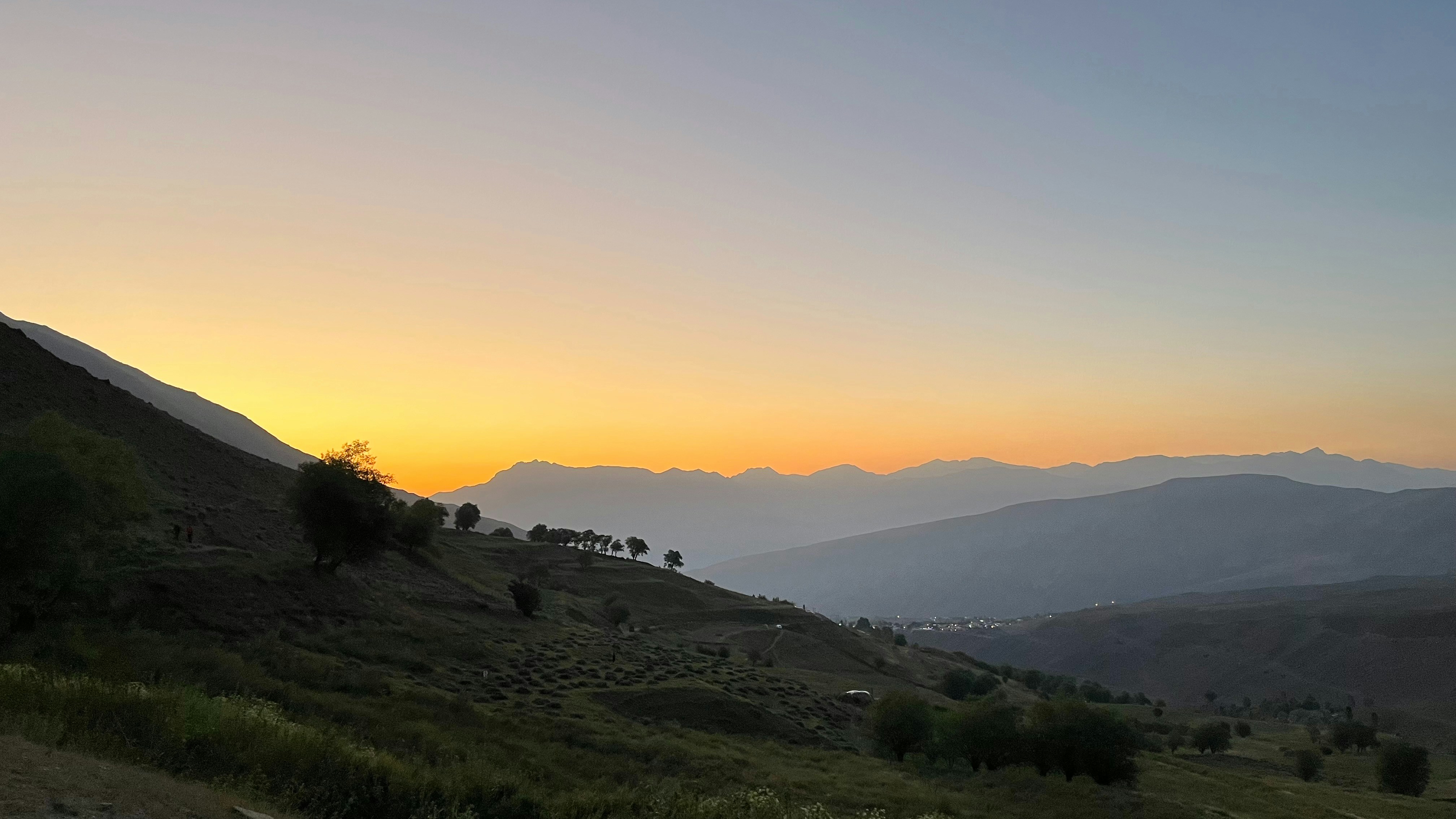 Scenic mountain landscape at sunset with orange sky