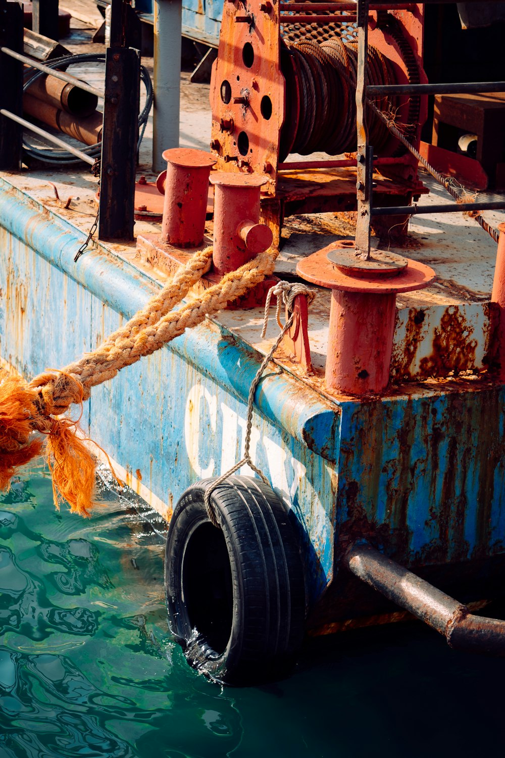 a rusty boat with a rope tied to it