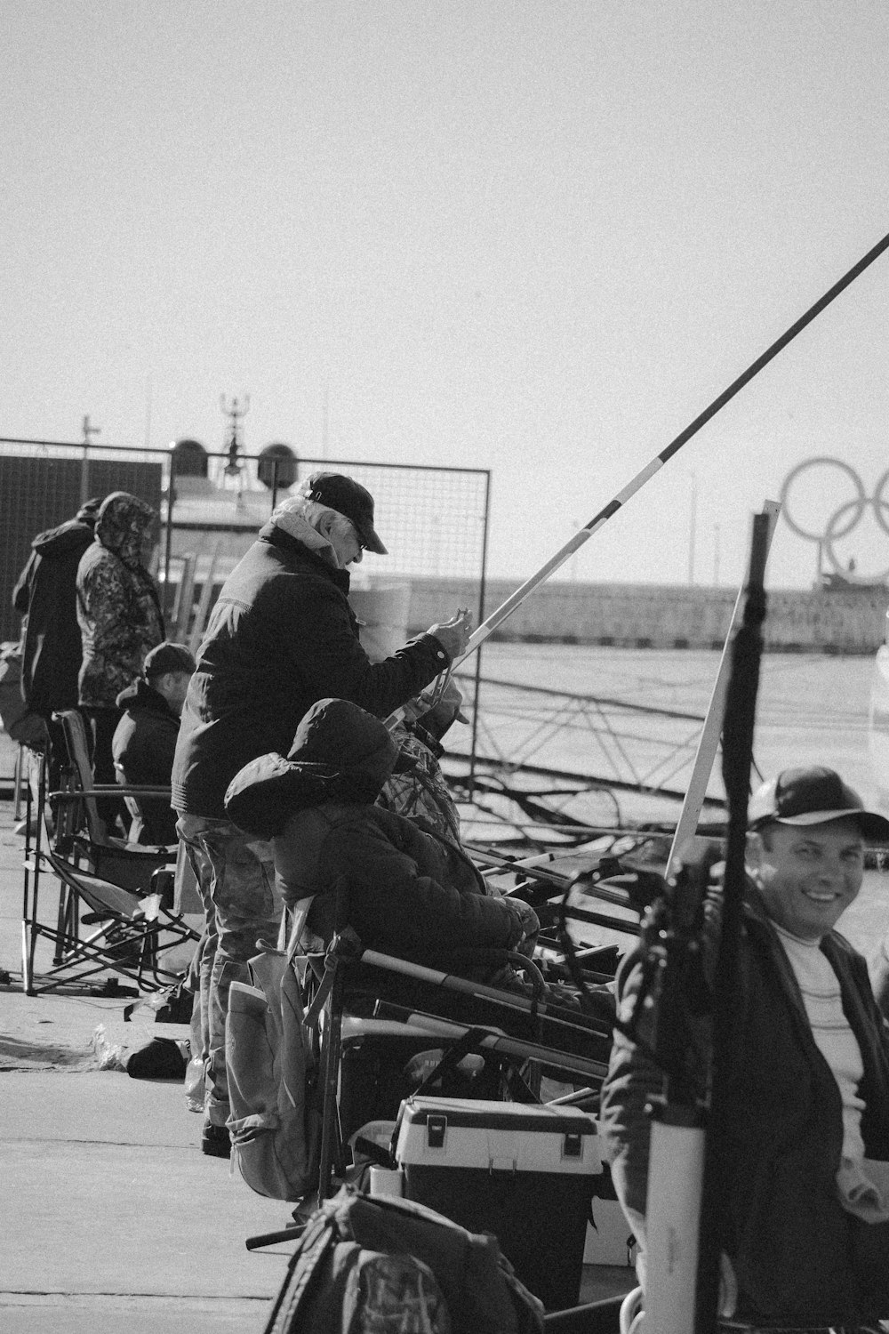 a black and white photo of people fishing