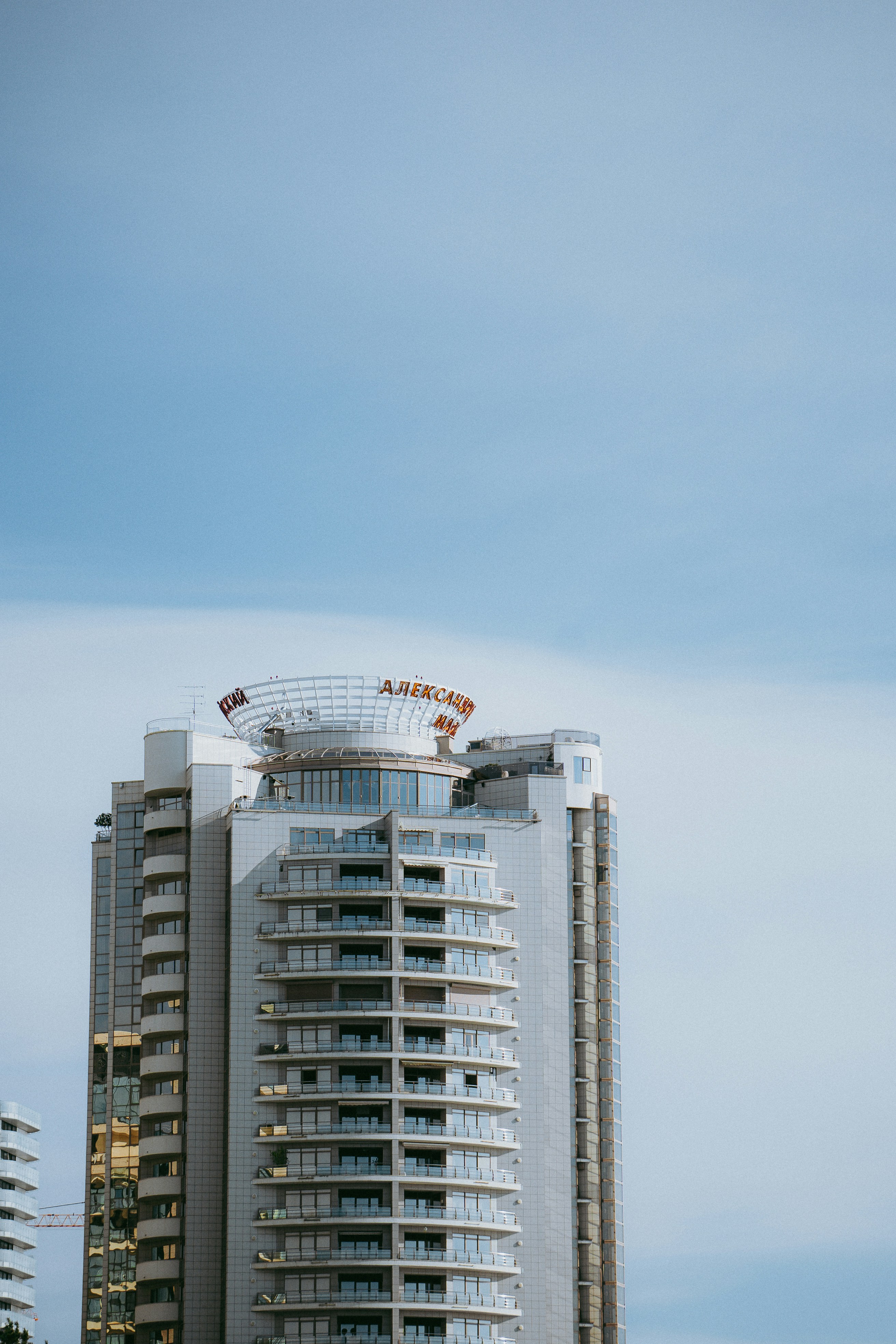 a tall white building with a sky background