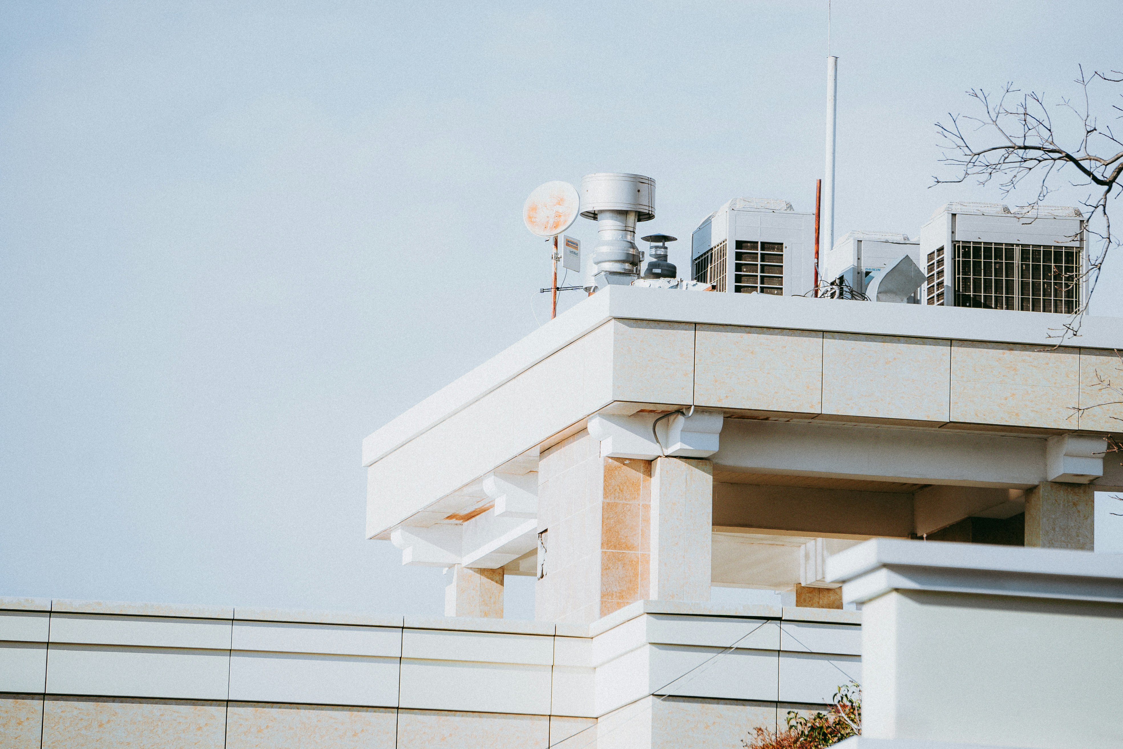 a view of a building with a tower and a satellite dish on top of it