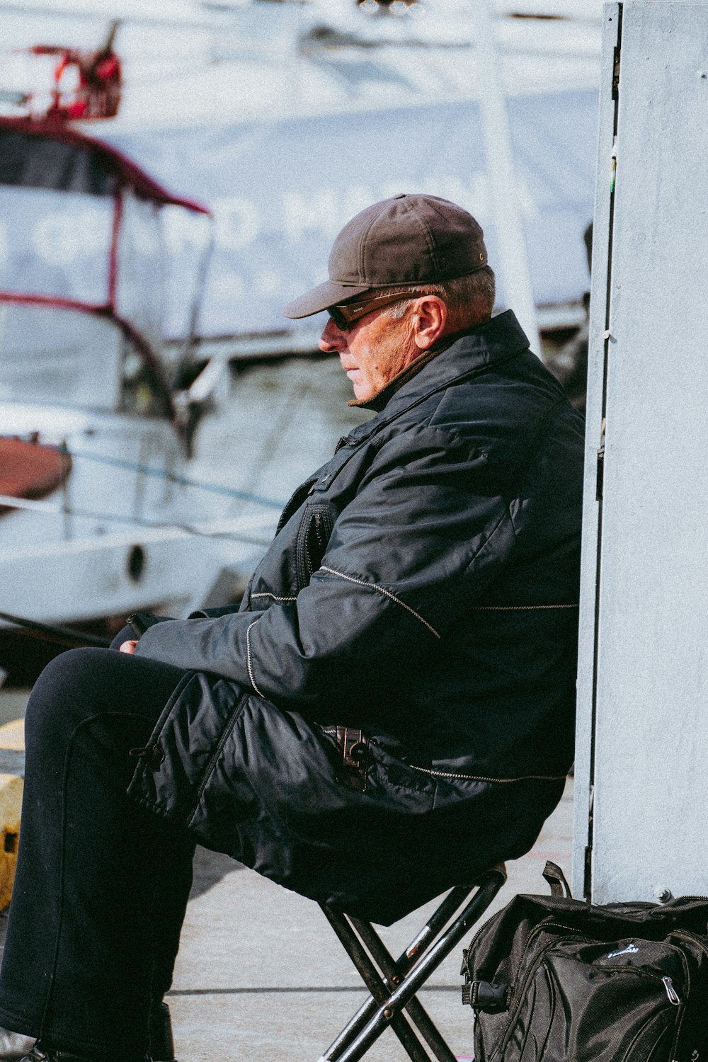 a man sitting in a chair next to a boat