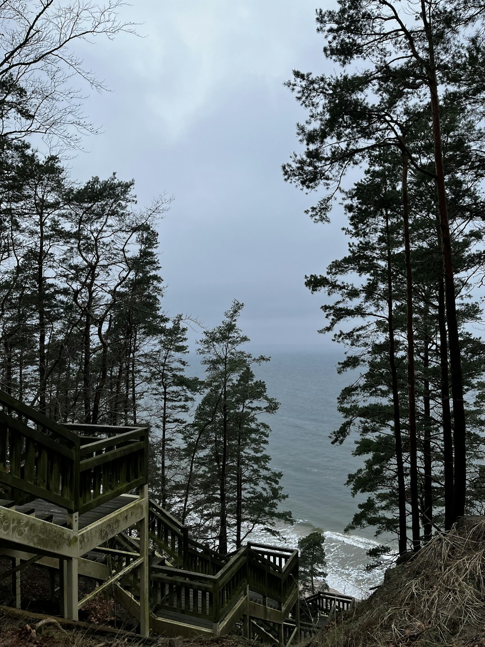 stairs lead down to the beach from a cliff