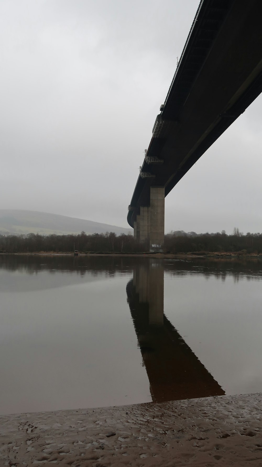 a bridge over a body of water on a cloudy day