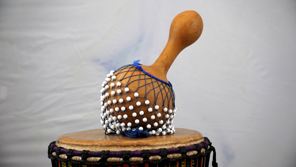 a drum with a wooden stick sticking out of it
