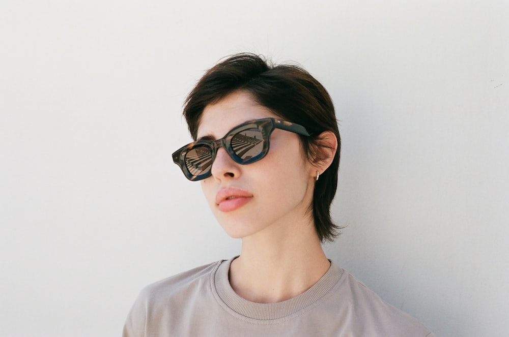 a woman wearing a pair of cat eye sunglasses