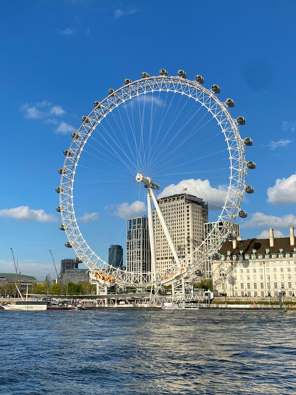 a large ferris wheel in the middle of a body of water