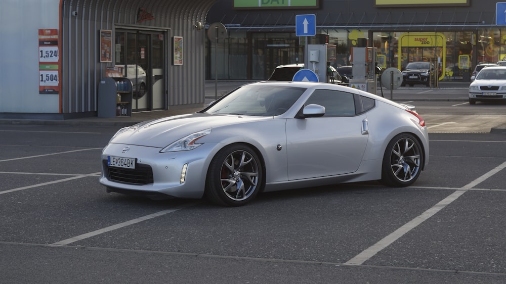 a silver sports car parked in a parking lot