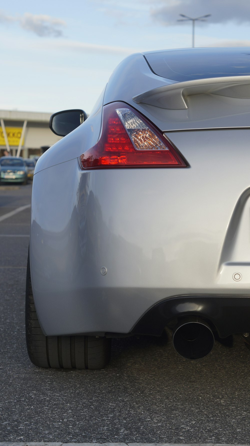 a silver sports car parked in a parking lot