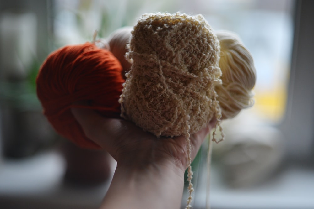 a person holding a ball of yarn in their hand