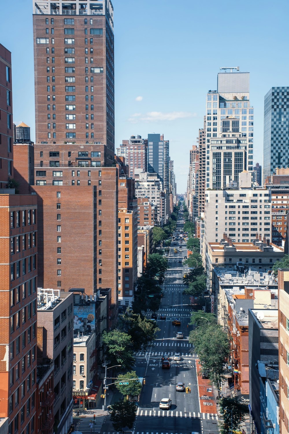 a view of a city street with tall buildings