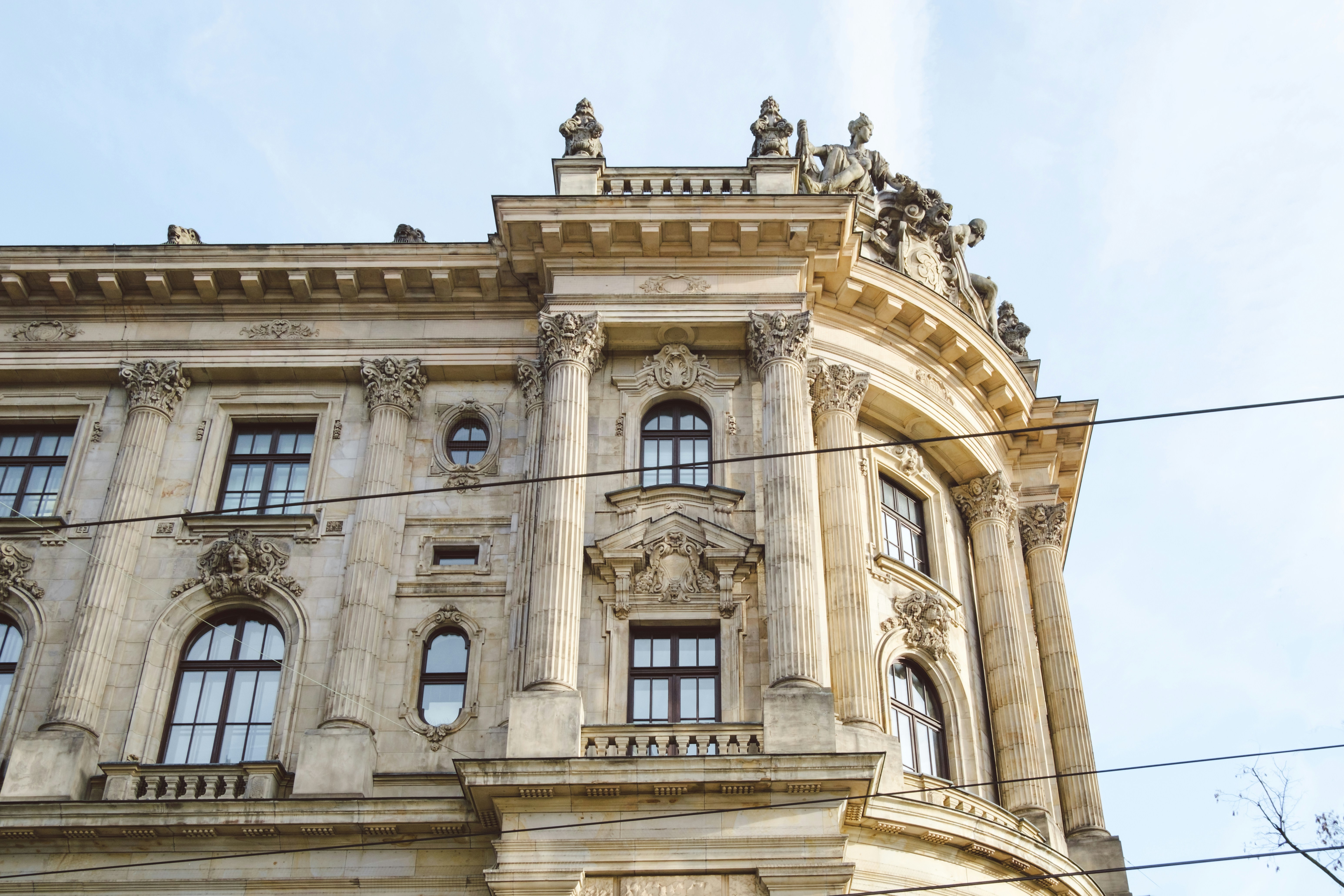 a tall building with many windows and a sky background