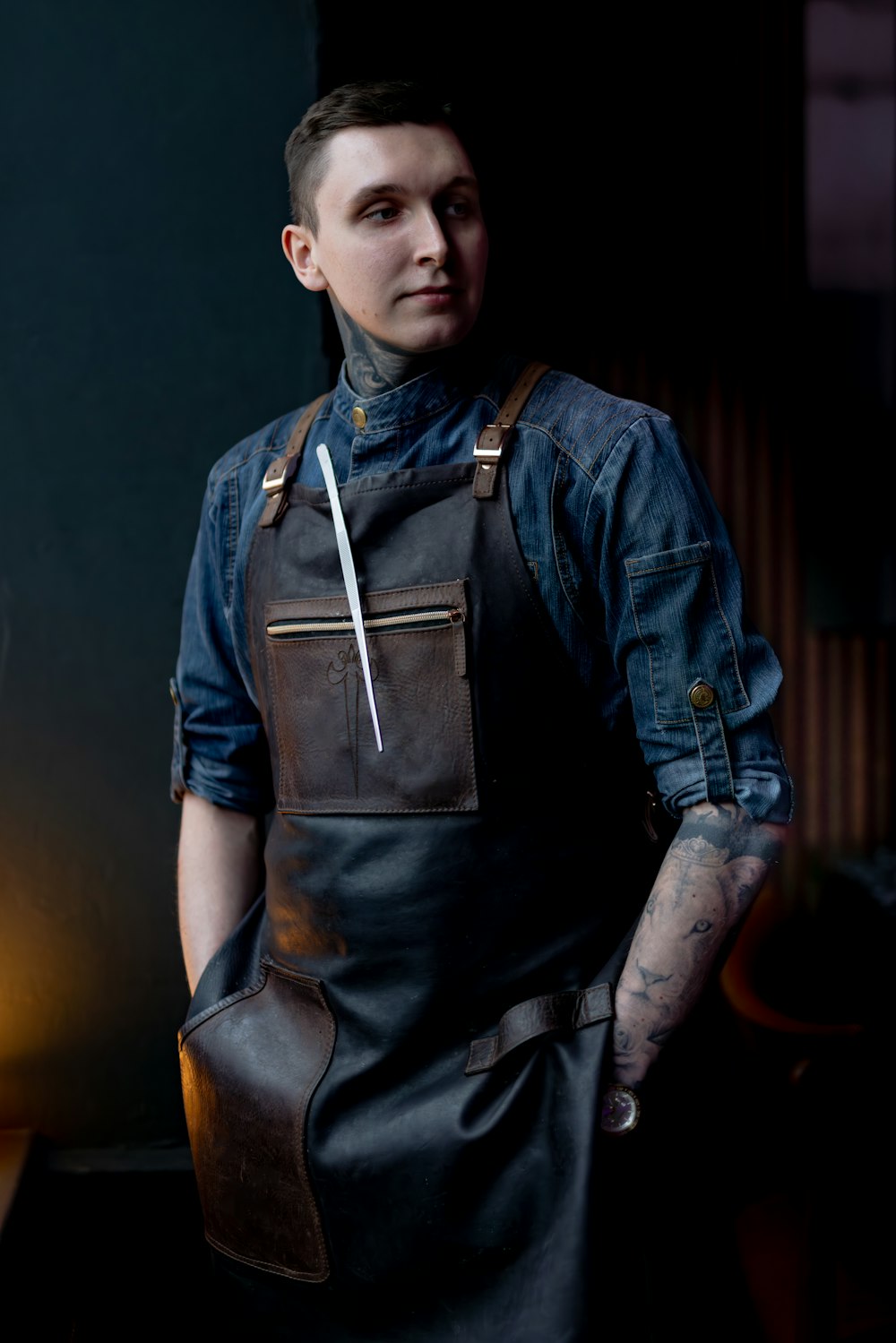 a man wearing a leather apron with a knife in his pocket
