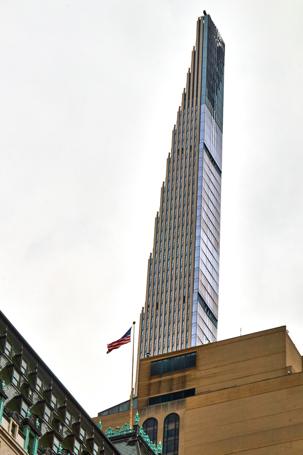 a tall building with a flag on top of it