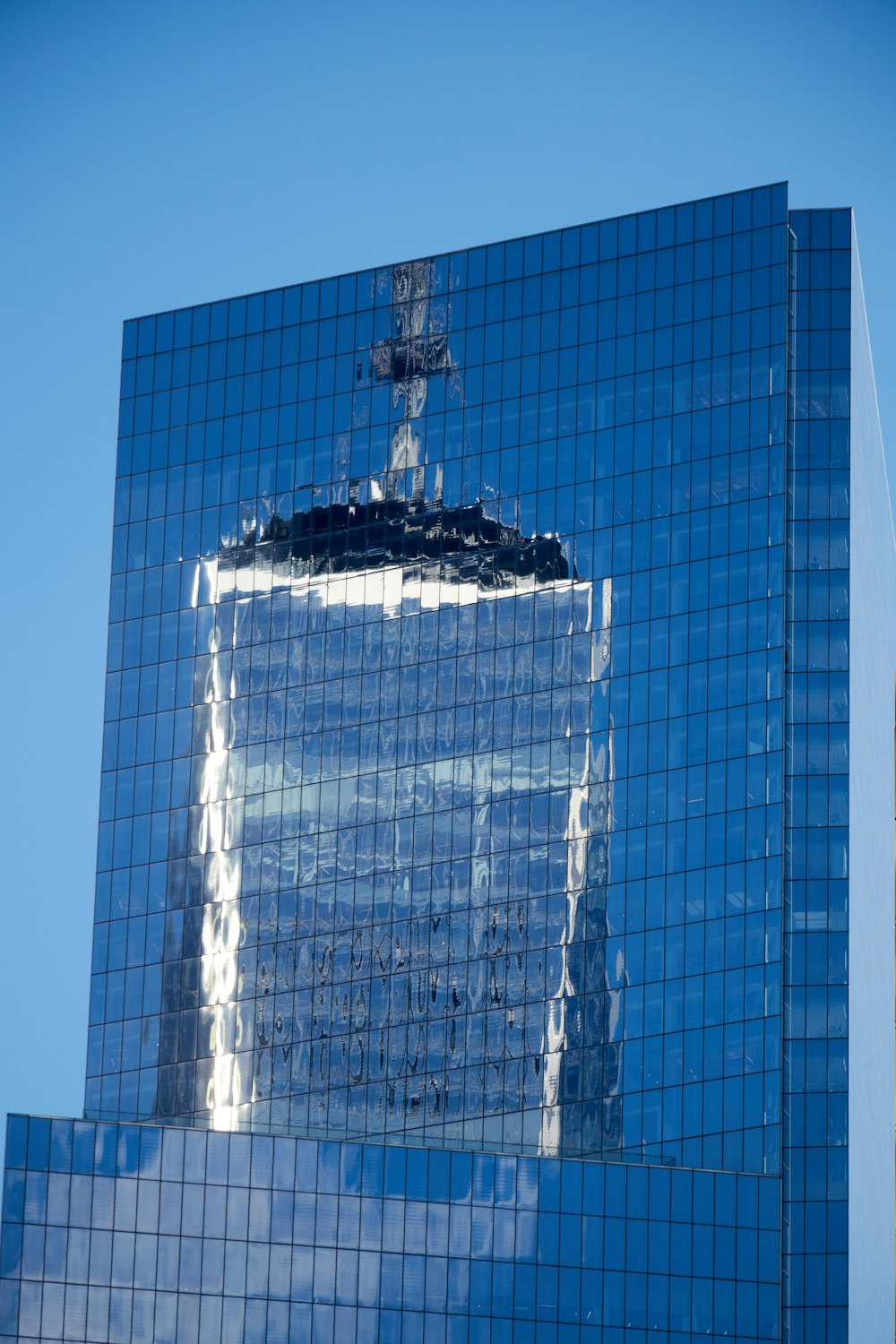 the reflection of a building in the windows of another building