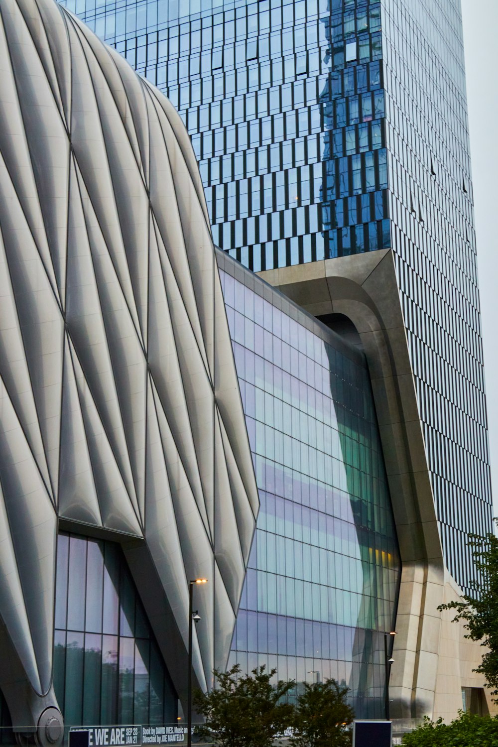 a tall building with a curved roof next to a tall building