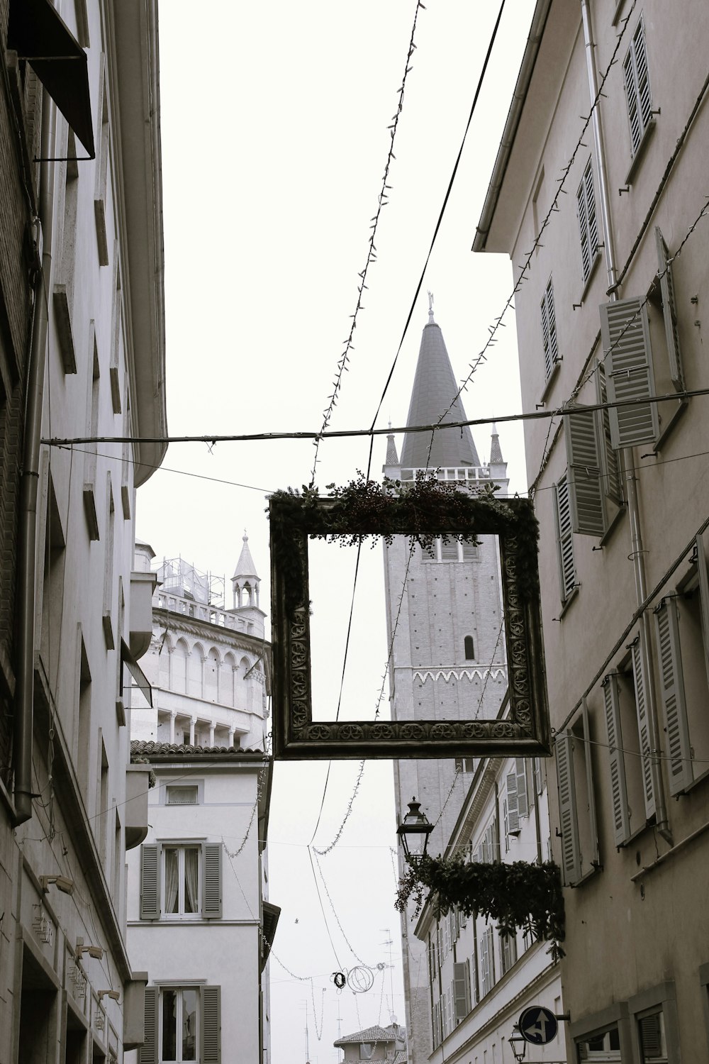 a picture frame hanging from a wire on a building