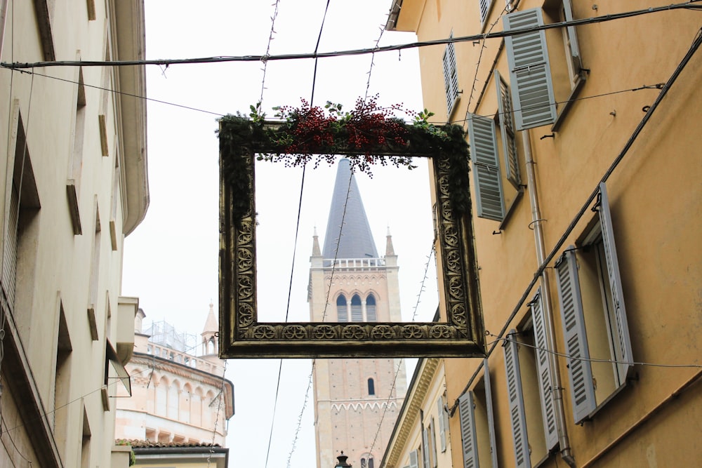 a picture frame hanging from the side of a building