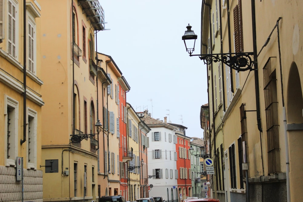 a city street lined with tall buildings and parked cars