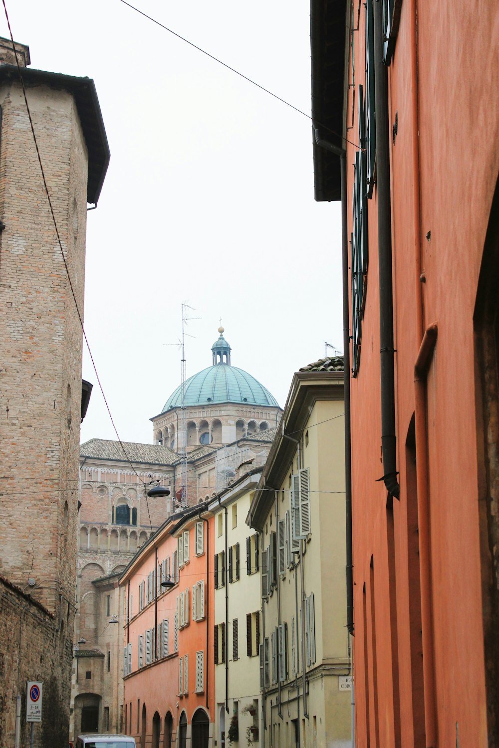 a city street with buildings and a dome in the background