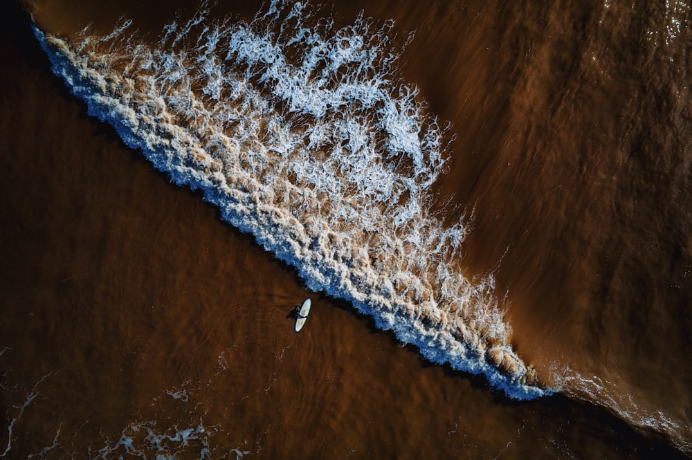 an aerial view of a surfboard in the water