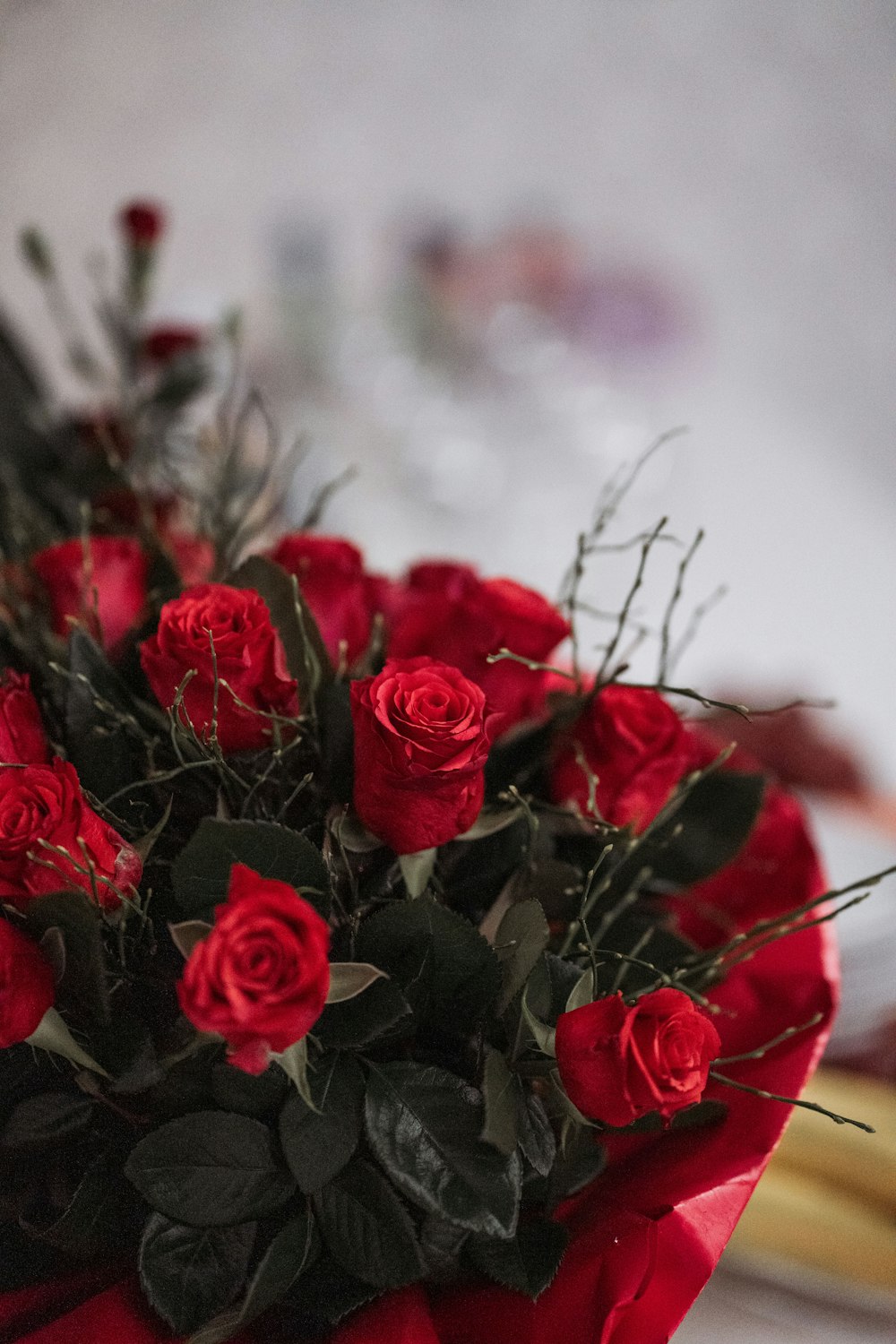 a bouquet of red roses sitting on top of a table