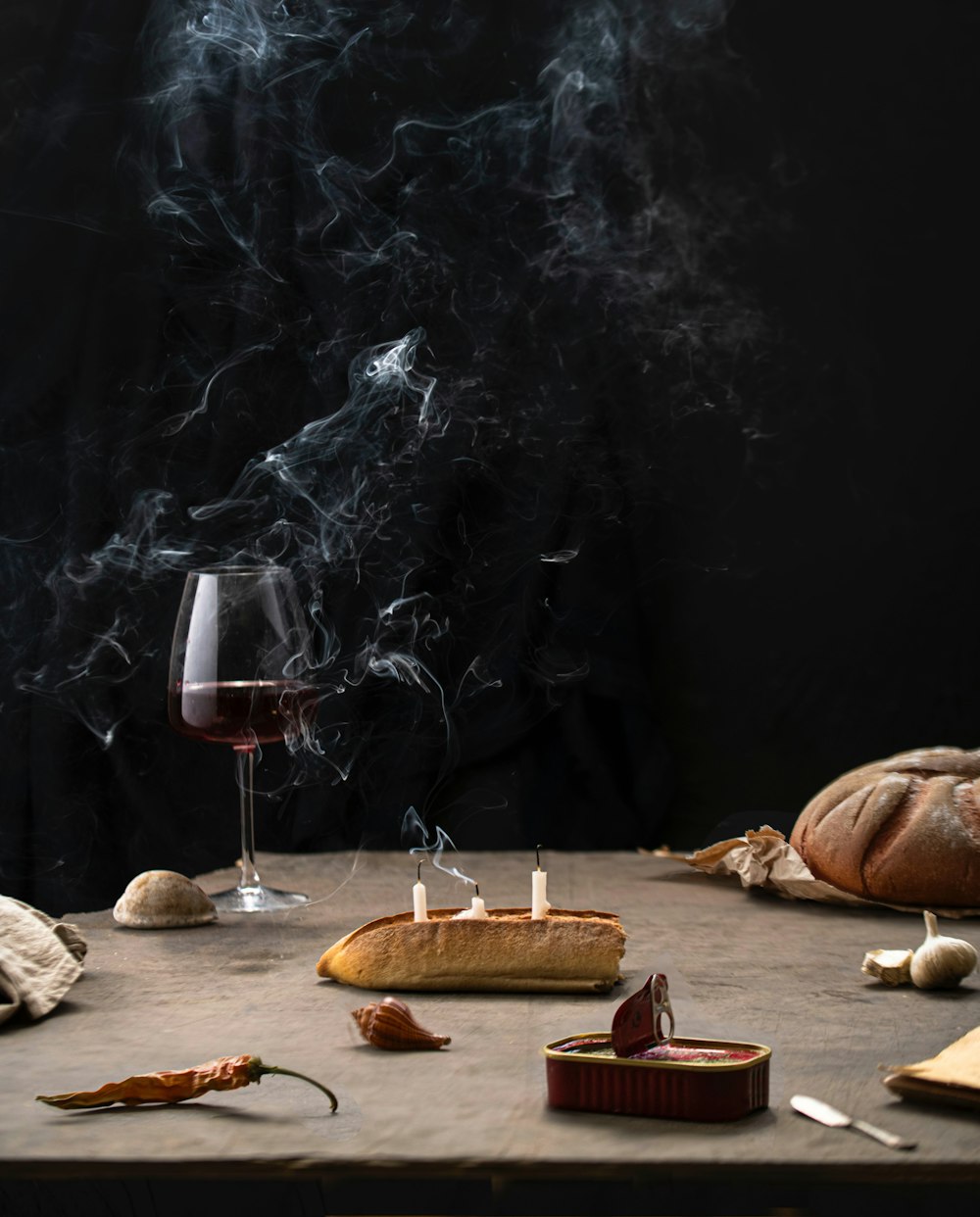 a table topped with bread and a glass of wine