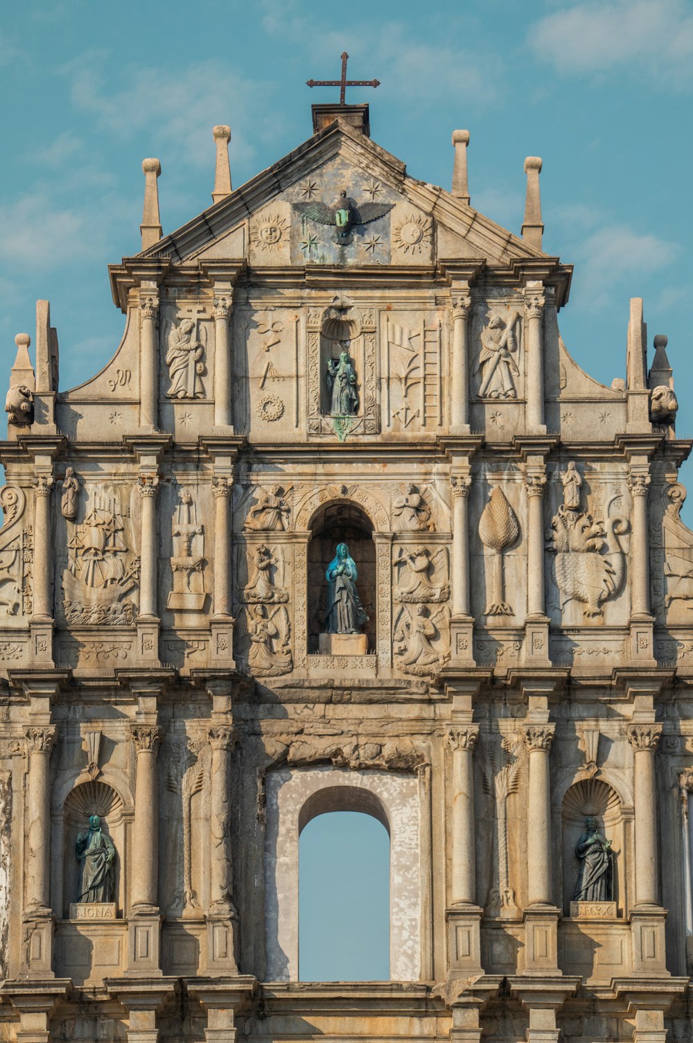 a large building with statues on the side of it