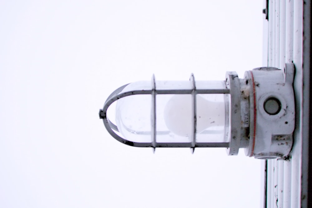 a street light with a white sky in the background