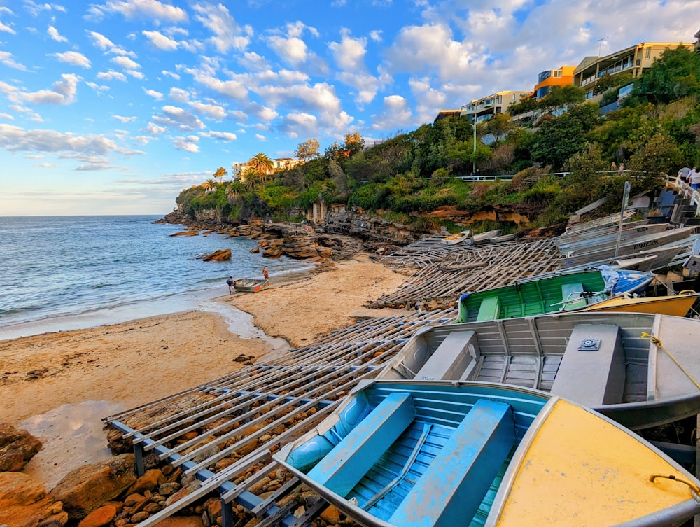 a group of boats sitting on top of a sandy beach