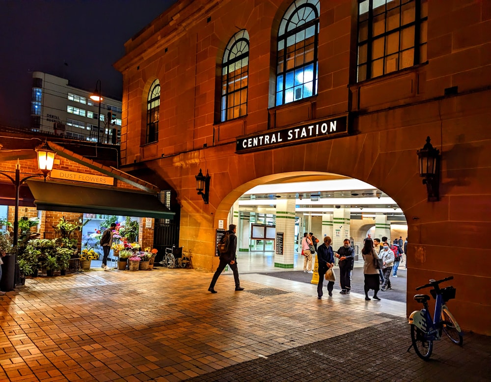 a group of people walking around a train station