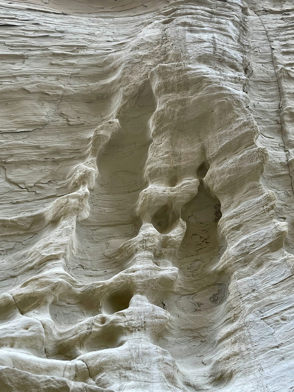 a close up of a rock formation with a bird perched on top of it