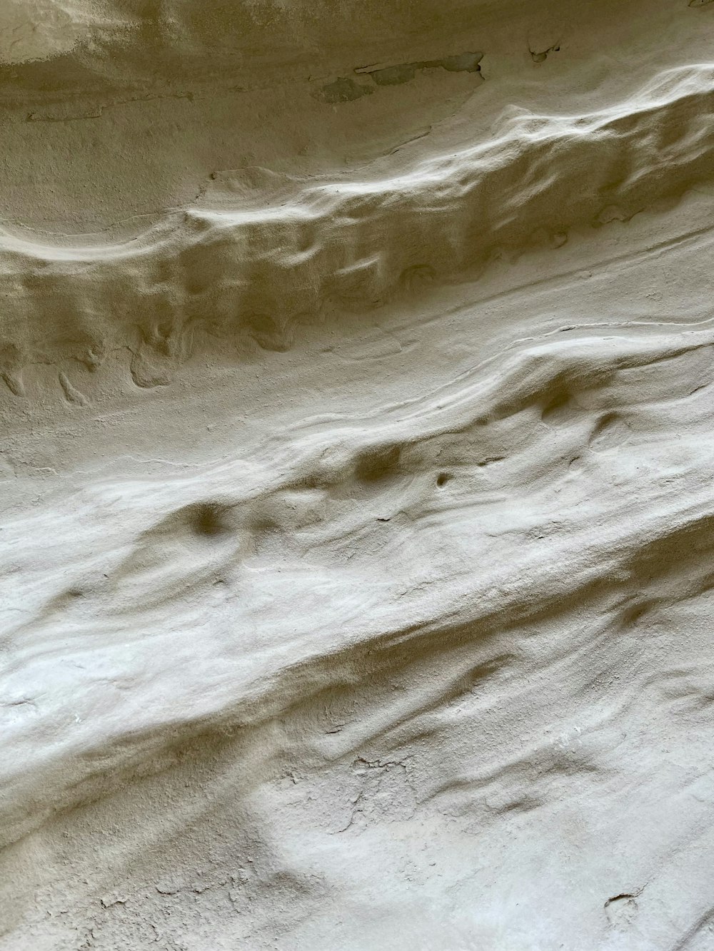 a person riding a snowboard down a snow covered slope