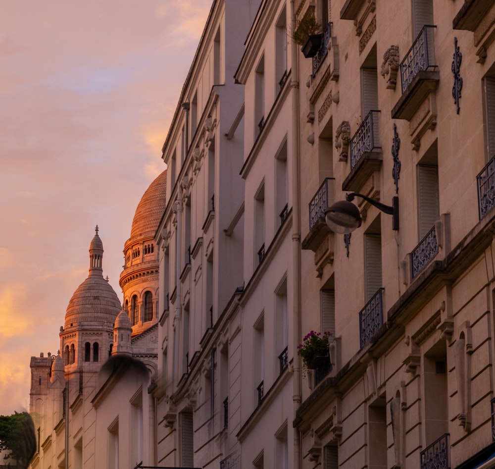 a row of buildings with a clock tower in the background