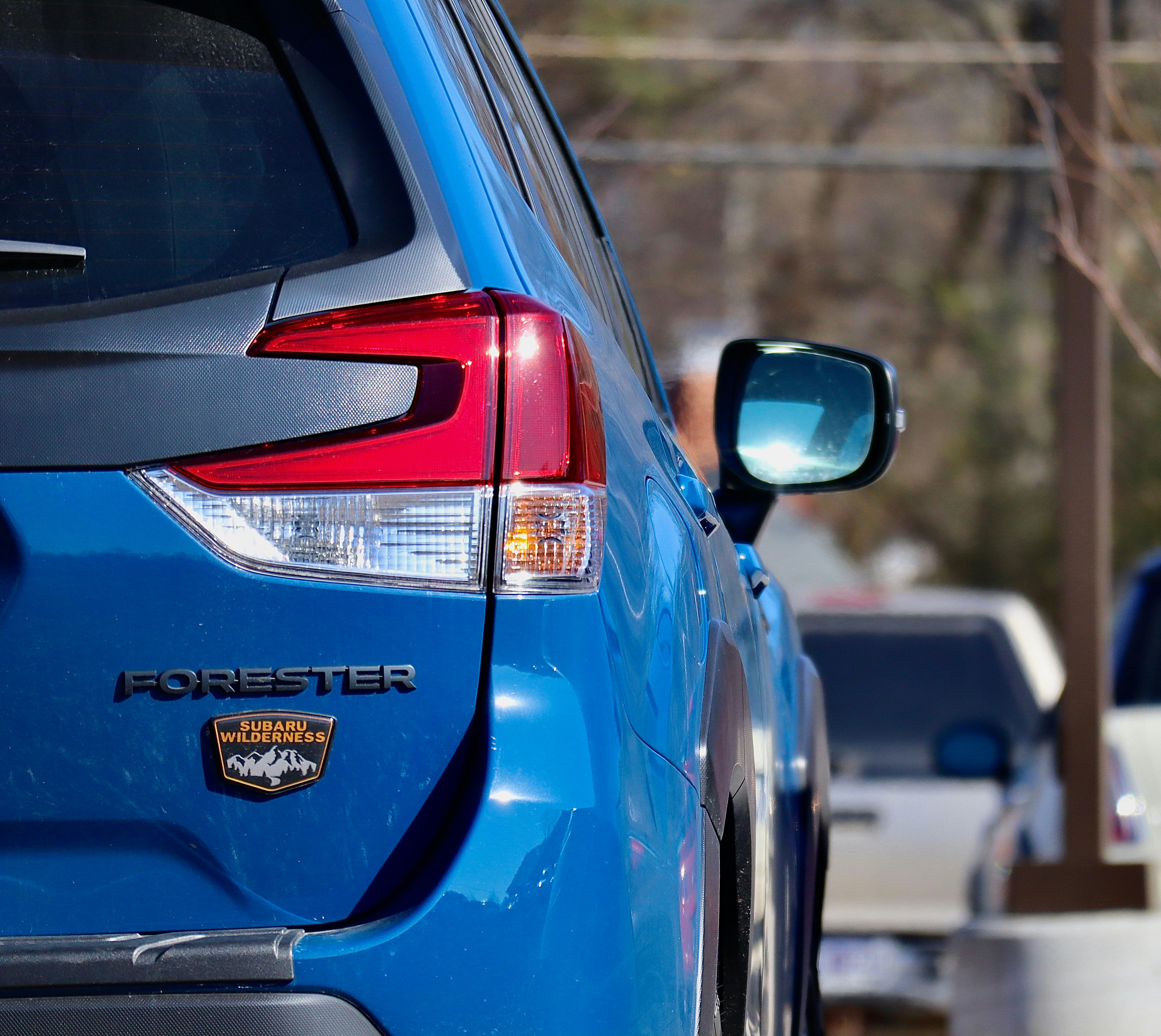 a close up of the tail lights of a blue car