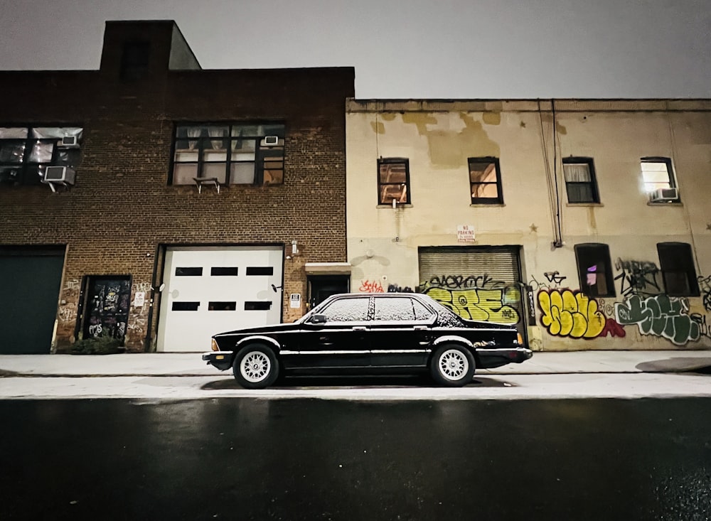 a black car parked in front of a building