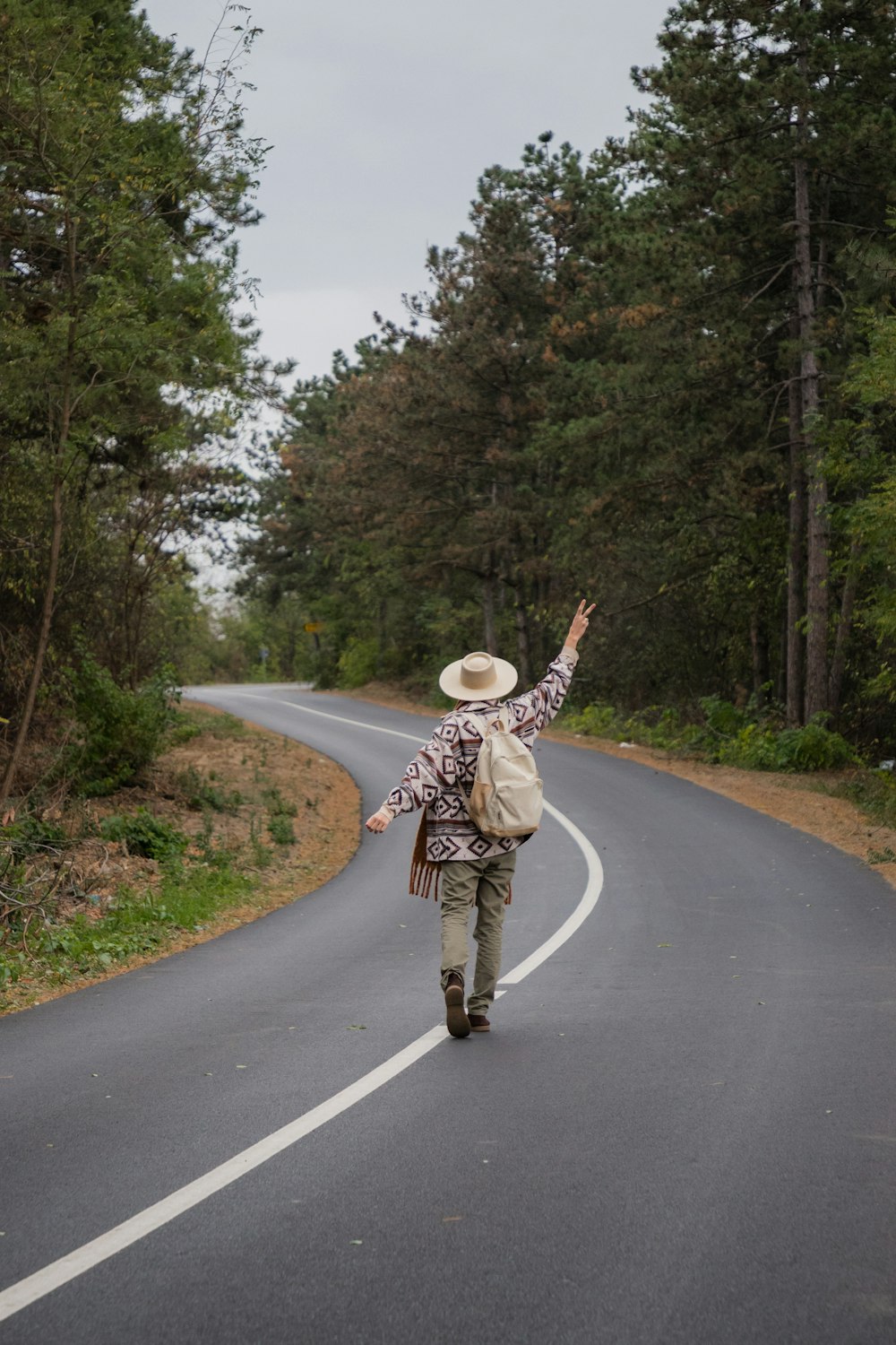 a person walking down a road with a backpack