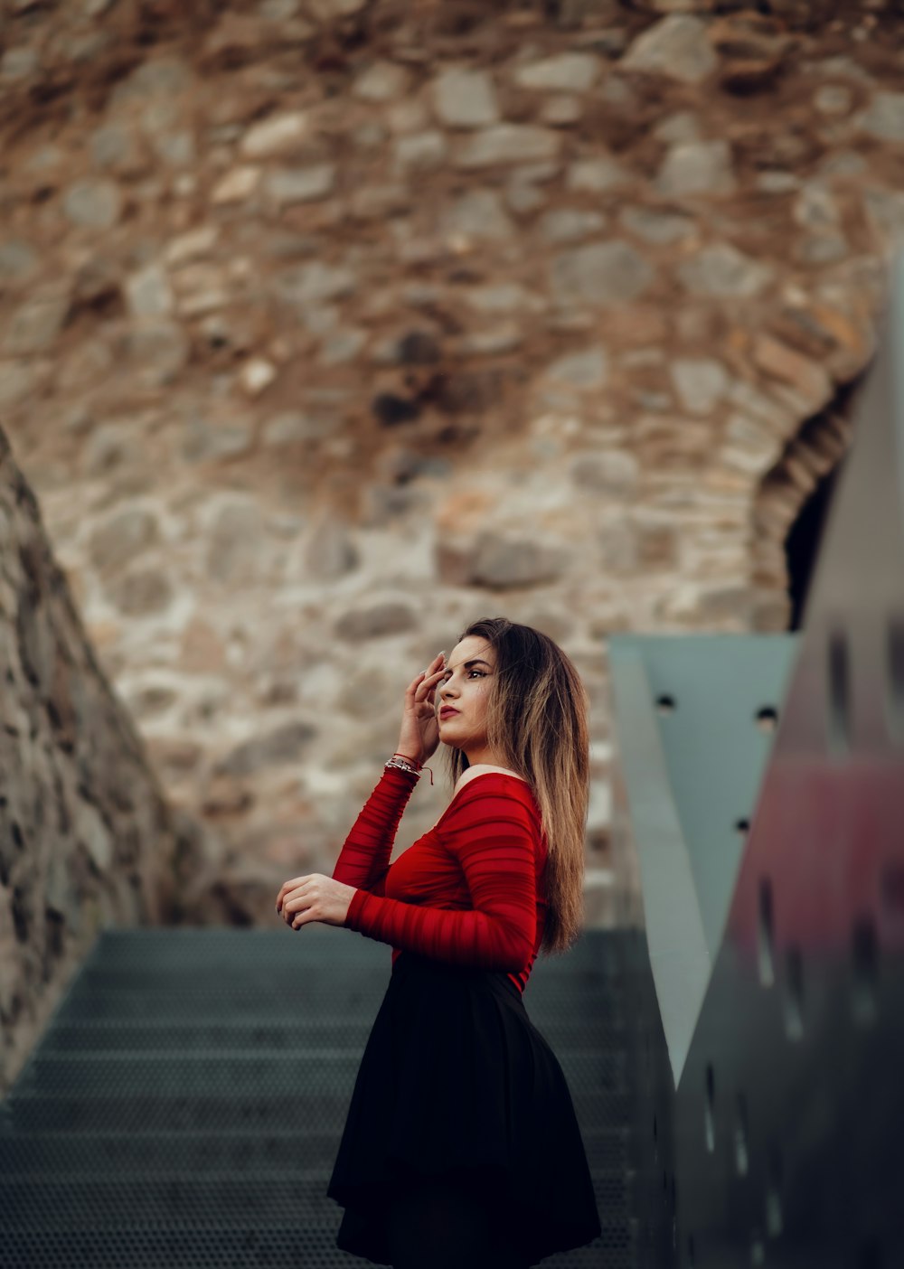 a woman in a red sweater is talking on a cell phone